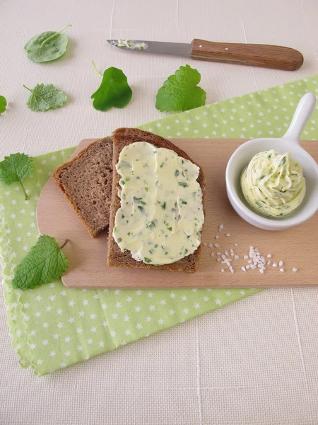 Sliced bread with herb butter — Stockfoto