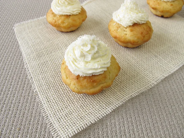 Coconut cupcakes with whipped cream — Stock Photo, Image