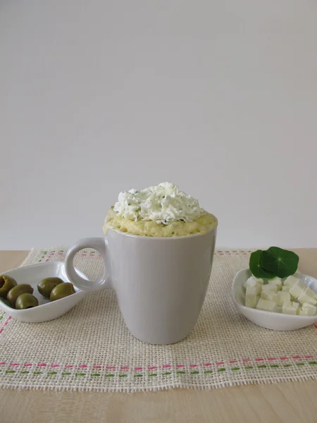 Mug cake with olives, feta cheese and herb cheese topping — Stock Photo, Image