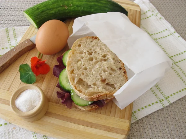 Cucumber sandwich in greaseproof paper bag for take away — Stock Photo, Image