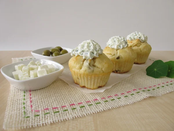 Cupcake with olives, feta cheese and herb cheese topping — Stock Photo, Image