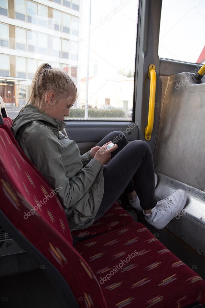 Teenage girl riding the bus