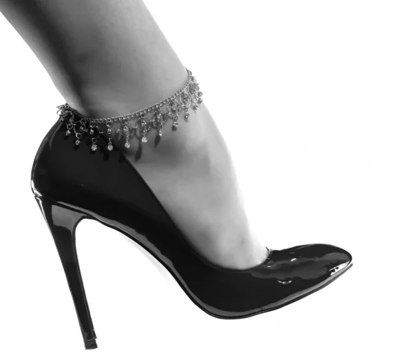 美しい女性の足白い光沢のある黒い特許の革の靴の装飾チェーン — ストック写真