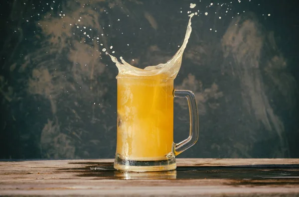 Becher Mit Kaltem Schäumendem Bier Und Spritzer Auf Einem Holztisch — Stockfoto