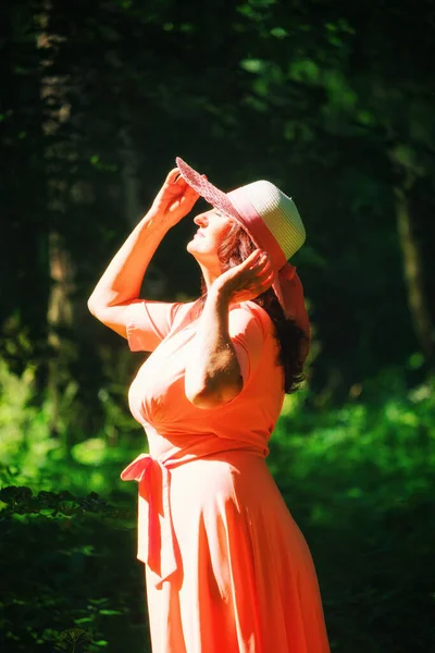 Hermosa Mujer Adulta Vestido Coral Largo Sombrero Ancho Camina Parque — Foto de Stock