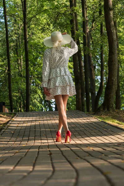 Schlanke Frau Kurzen Sommerkleid Breitem Hut Und Stöckelschuhen Morgens Park — Stockfoto