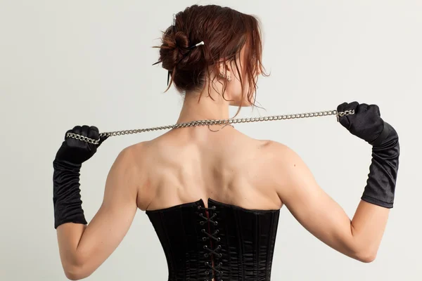 Woman in a corset and  chain — Stock Photo, Image