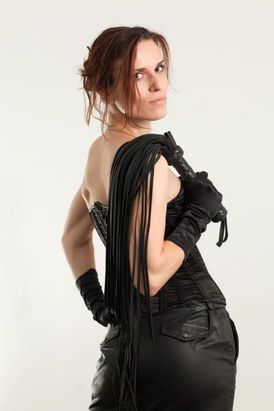Woman in a corset and whip — Stock Photo, Image