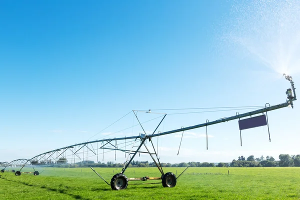 Spray water machine in grassland — Stock Photo, Image