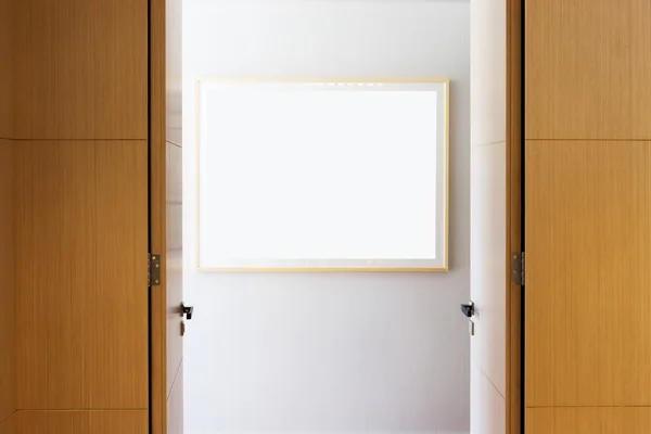 Blank picture frame on wooden wall — Stock Photo, Image