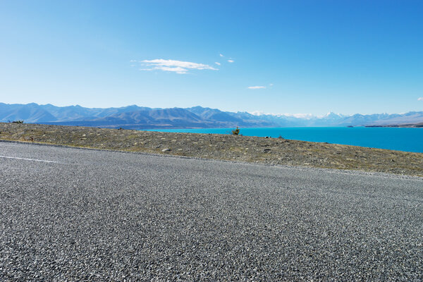 asphalt road near lake in New Zealand