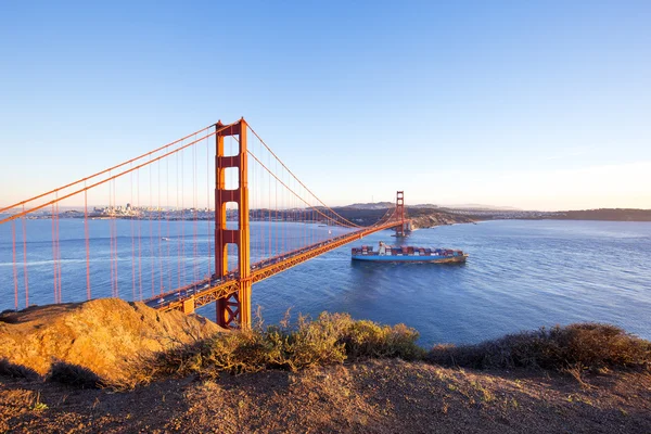 Χρυσό Gate Bridge και κοντέινερ πλοίο στη θάλασσα — Φωτογραφία Αρχείου
