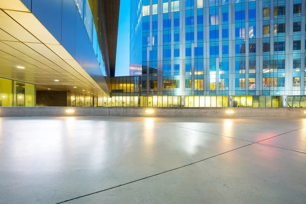 empty floor and modern buildings at night