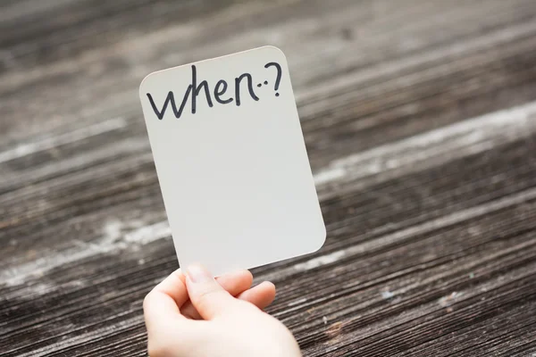 Person holds card with text when...? — Stock Photo, Image