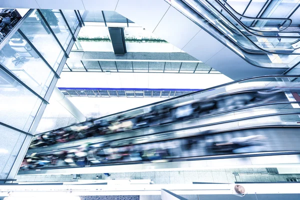 Escalator with crowded people in modern building — Stock Photo, Image