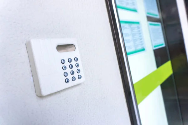 Modern hi-tech door key on wall — Stock Photo, Image