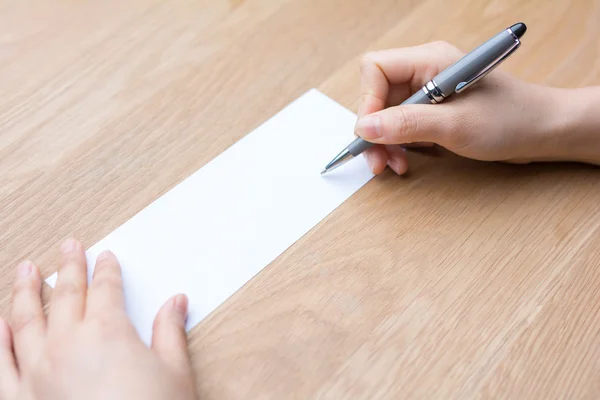 Businessman writing on white paper — Stock Photo, Image