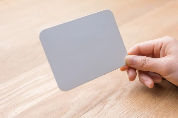 Woman's hand holding white paper — Stock Photo, Image