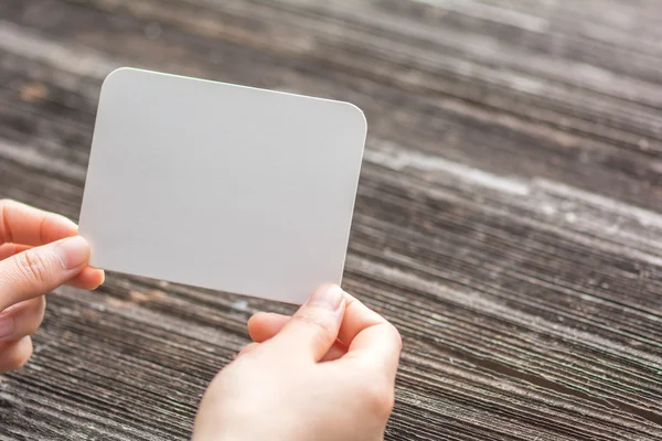 Woman's hands holding blank paper — Stock Photo, Image