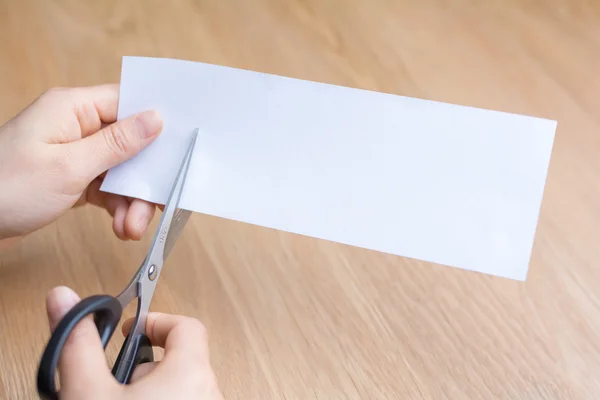 woman cutting white paper