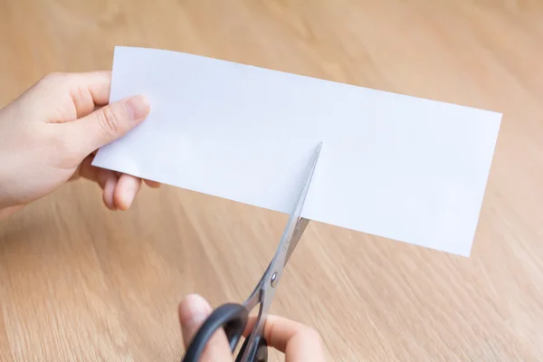 woman cutting white paper