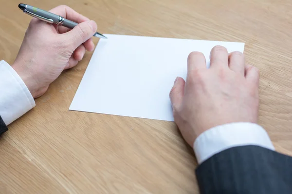 Businessman writing on white paper Stock Photo