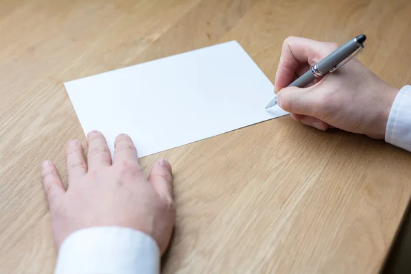 Biznesmen piszący na białej księdze — Zdjęcie stockowe