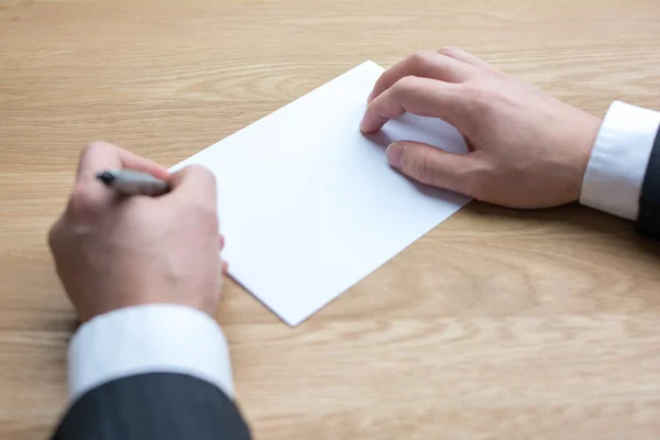 Businessman writing on white paper Royalty Free Stock Images