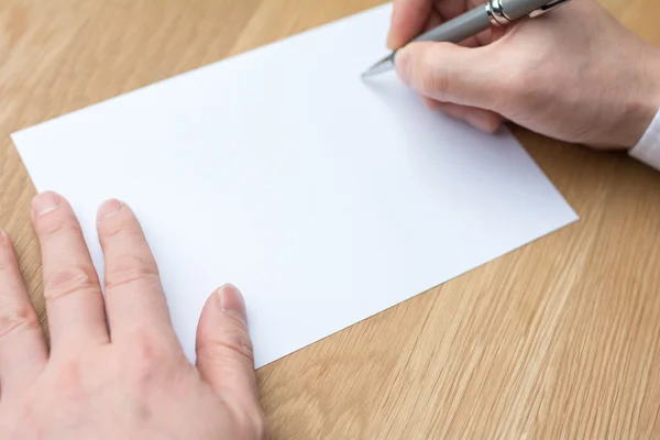 Businessman writing on white paper — Stock Photo, Image