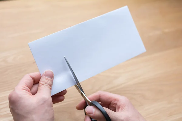 Businessman cutting paper by scissors — Stock Photo, Image