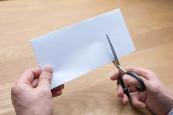 Businessman cutting paper by scissors — Stock Photo, Image