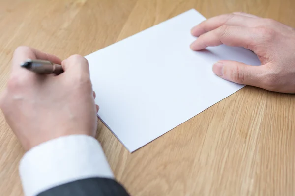 Businessman writing on white paper — Stock Photo, Image