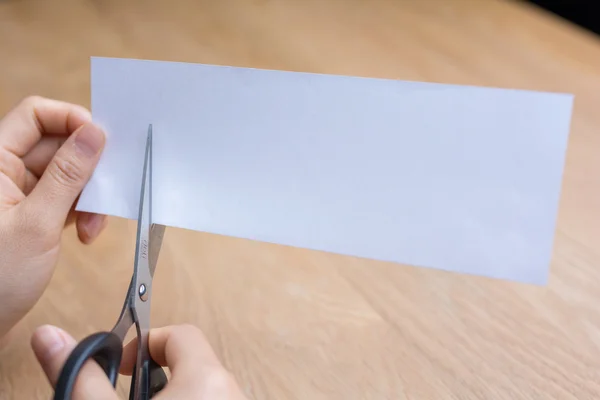 woman cutting white paper