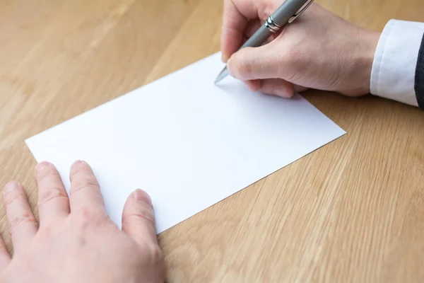 Businessman writing on white paper Stock Picture
