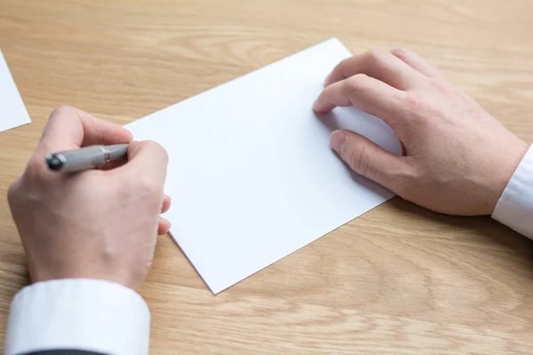 Businessman writing on white paper — Stock Photo, Image