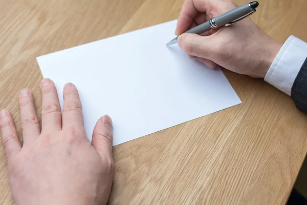 Businessman writing on white paper — Stock Photo, Image