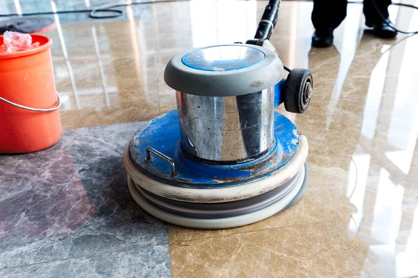 People polishes floor indoors — Stock Photo, Image