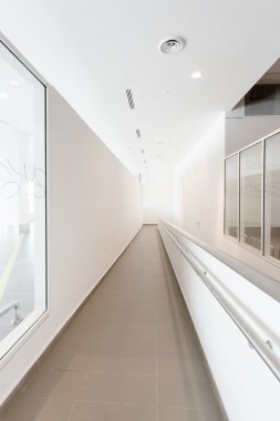 Modern ofis koridorunda tekerlekli sandalye yolu ile
