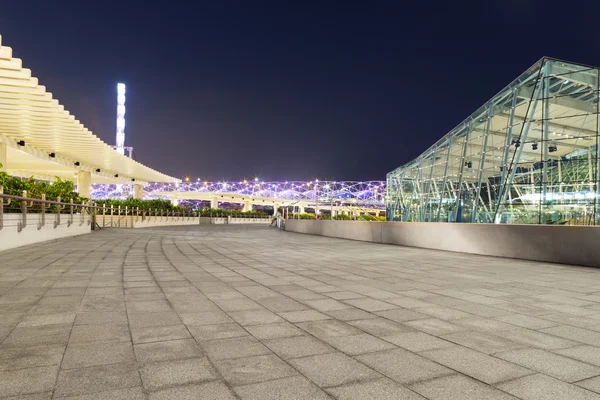 Pavement on the roof of building and cityscape at night — Stock Photo, Image