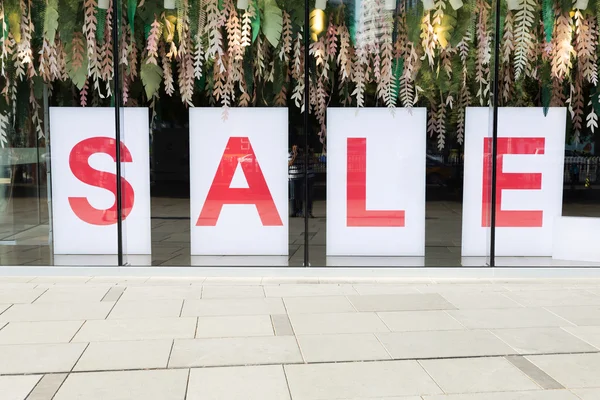 Sale poster in the fashion shopfront — Stock Photo, Image