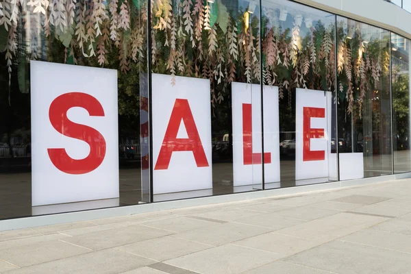 Sale poster in the fashion shopfront — Stock Photo, Image