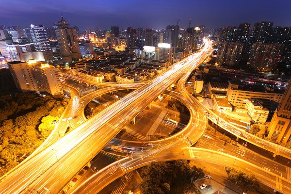 Modern city traffic and skyline at night Shanghai.