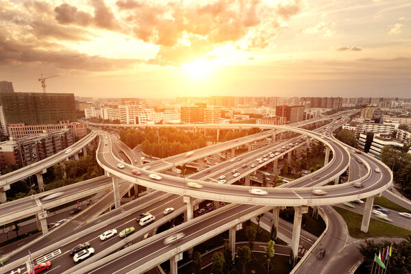 skyline and traffic trails on highway intersection