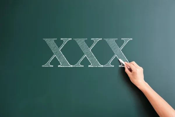 Xxx written on blackboard — Stock Photo, Image