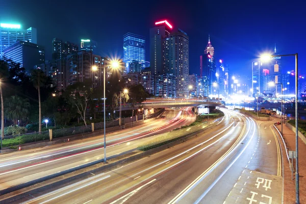 Traffic blur motion trails in modern city street at night — Stock Photo, Image