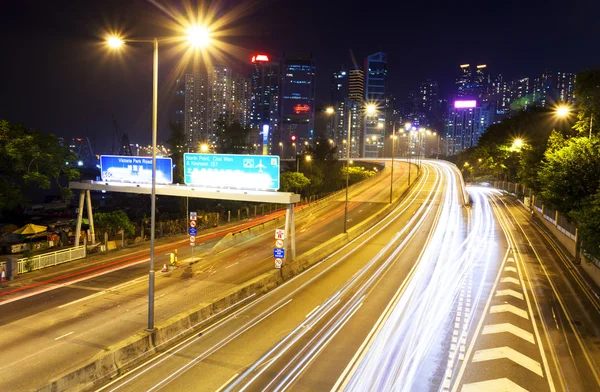 Traffic blur motion trails in modern city street at night — Stock Photo, Image