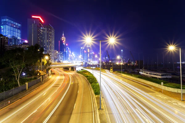 Traffic blur motion trails in modern city street at night — Stock Photo, Image