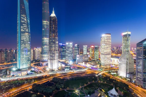 Skyscrapers in modern city at night — Stock Photo, Image