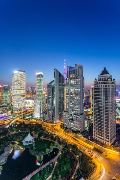 Skyscrapers in modern city at night — Stock Photo, Image