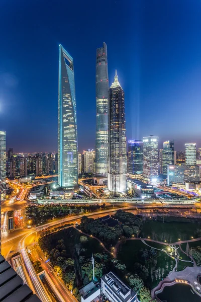 Skyscrapers in modern city at night — Stock Photo, Image
